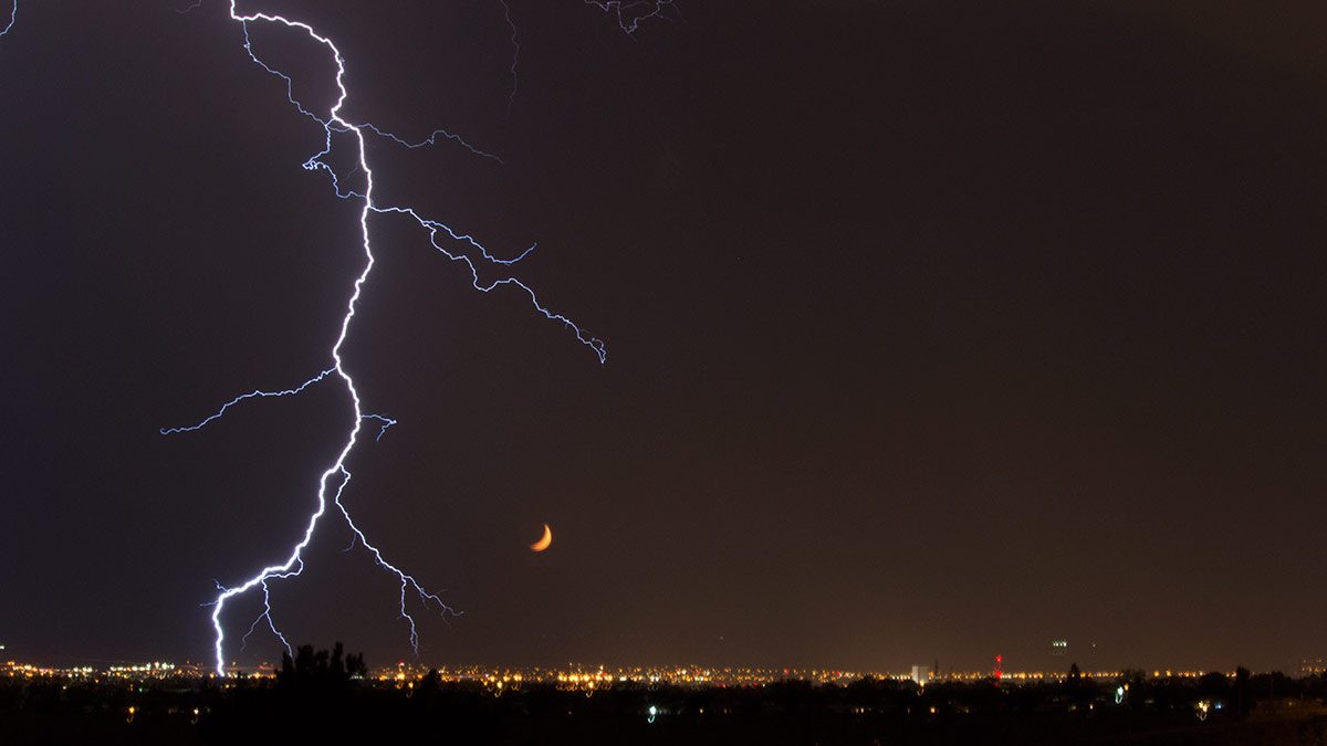 Lightning and moon set over albuquerque